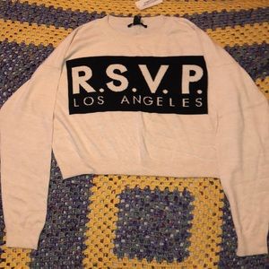 Cropped cream and black sweater.